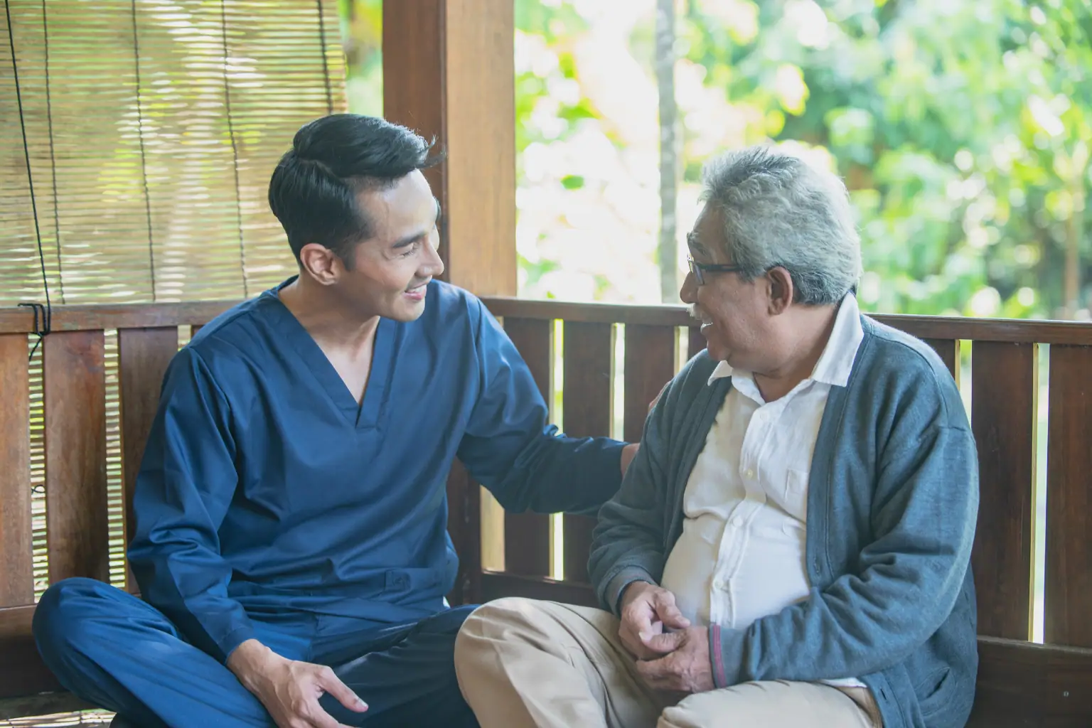 Support worker sitting down with senior